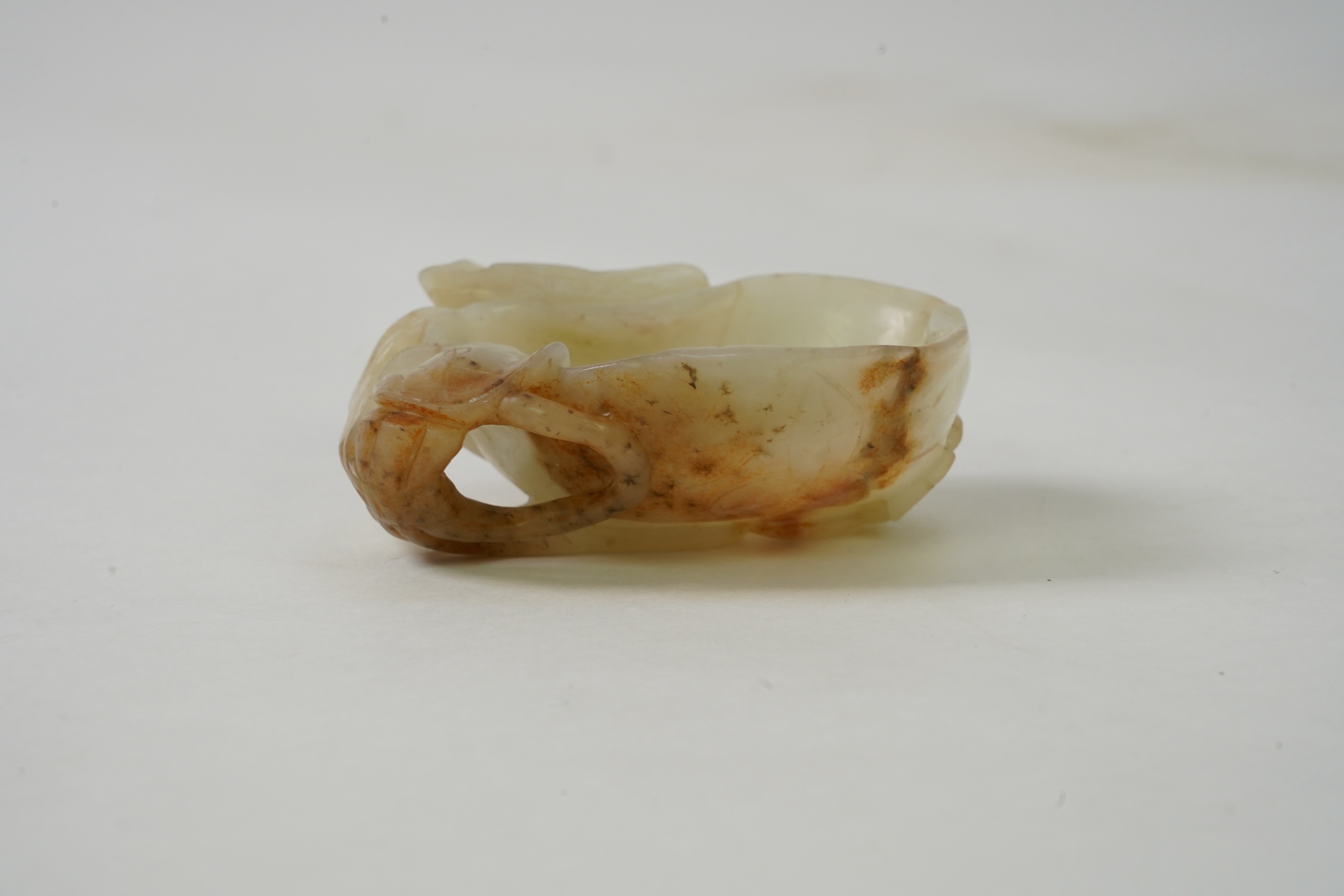 A Chinese pale celadon and russet jade brushwasher, Ming dynasty, 16th/17th century
